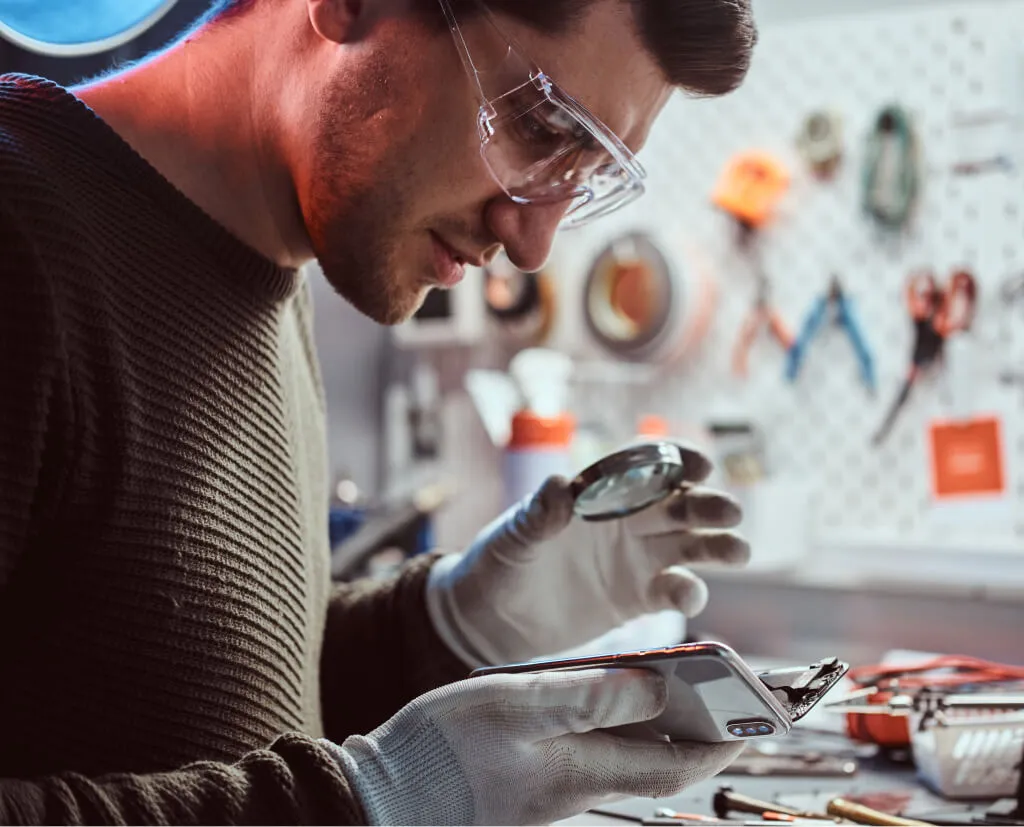Technician repairing a damaged smartphone