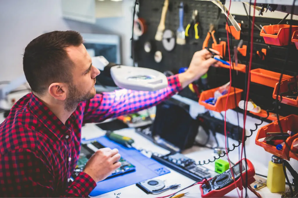 Technician repairing a laptop at the workbench